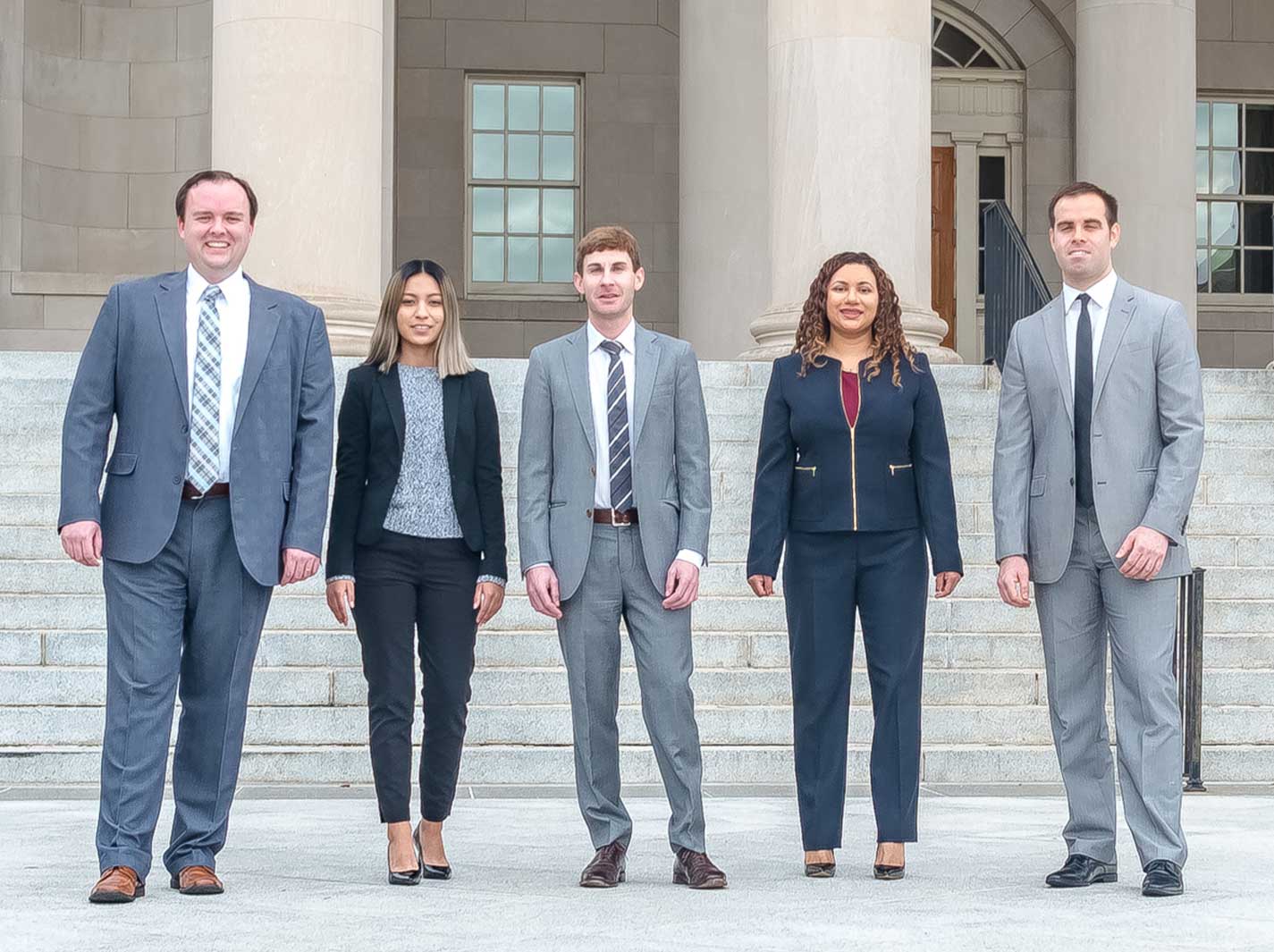 The DCWageLaw team standing at the steps of a D.C. courthouse